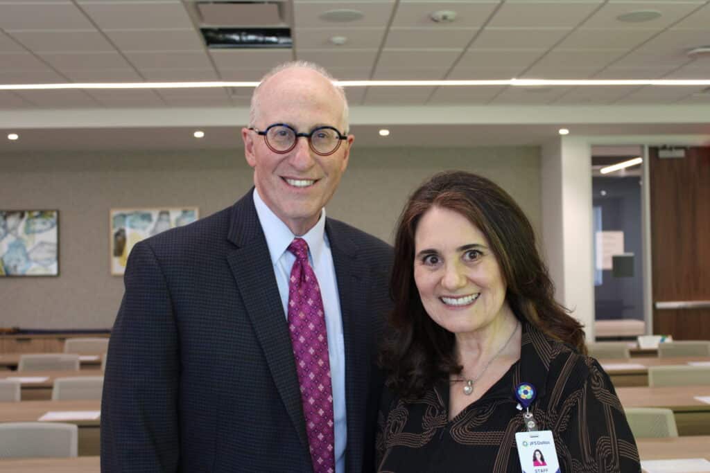 Presenter Mark Kreditor and JFS Dallas Holocaust Survivor Care Program Director Yaffa Podbilewicz-Weinberg, PhD, pose together before the program.